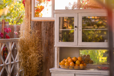 Veranda of countryside house in autumn season. Autumn arbor, with yellow tree near it. . Autumn...