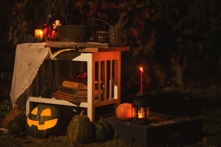 Happy halloween Carving pumpkin on the table in the garden. Happy family preparing for Halloween. background photoの写真素材
