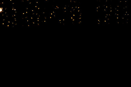 Christmas decorations lights on black out side, new year streets