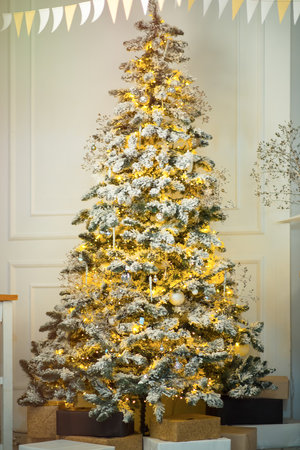 Christmas Living Room, Featuring an Christmas Tree Adorned with Spheres and Stars, Alongside Garlands and Gift Boxesの写真素材