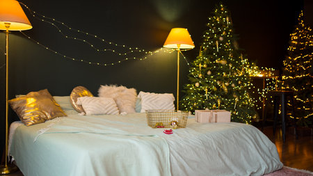 A charming Christmas bedroom with a decorated tree, Ideal for seasonal and holiday themes. Christmas timeの写真素材