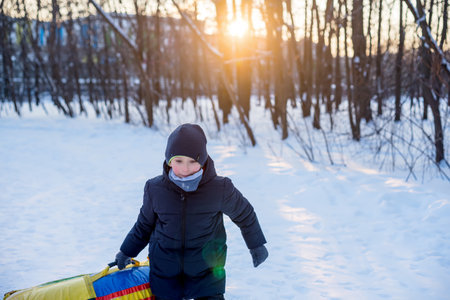 Winter recreation and fun, snow, flat sleddingの写真素材