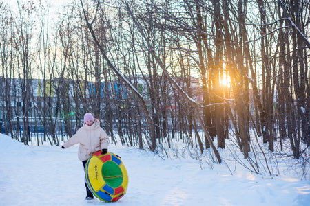 Winter recreation and fun, snow, flat sleddingの写真素材