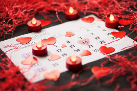 Flat lay top view of the holiday for Valentines Day with the date of 14 February in the calendar, the layout on the table in pinkの写真素材