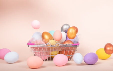 Different color eggs in mini shopping trolley. Concept delivery home purchase for easter eggs hunt....