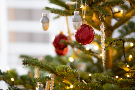 Modern design Christmas tree decorated with balls and garlands - navy red,grey, silver. Winter holidays composition. Close up. Beautifully decorated Christmas tree with bright ballsの写真素材