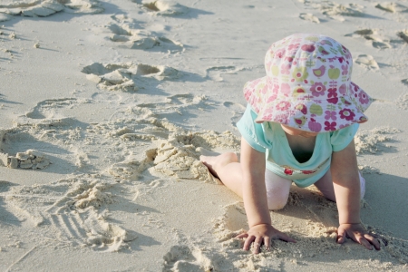 Toddler playing on beach 1の写真素材