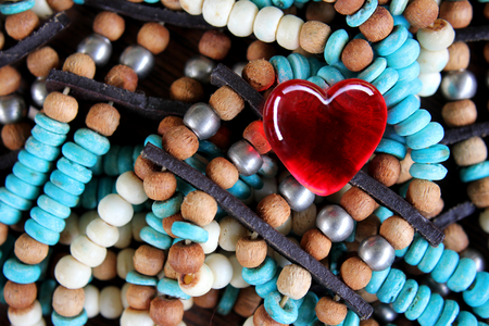 Red Glass Heart on Turquoise and brown beadsの写真素材