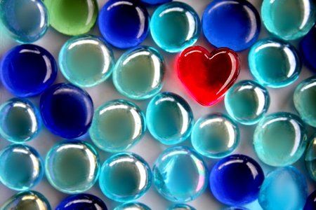 Red Glass Heart with Soft Blurred blue beadsの写真素材