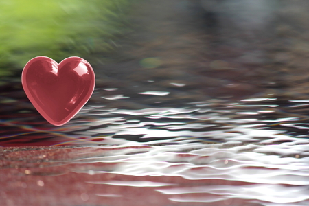 Red Heart on soft focus water backgroundの写真素材
