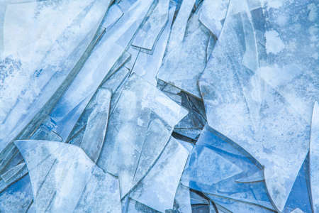 Background of broken glass on the floor in blue tones.の写真素材