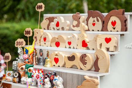 Rostov region, stanitsa Starocherkasskaya, Russia. 02/08/2020. Wooden dolls and toys in the form of loving creatures at rural fair.のeditorial素材