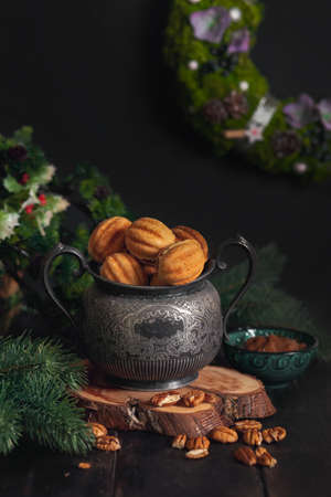 Russian traditional homemade cookies Nuts with condensed milk on an vintage jar on a wooden stand...