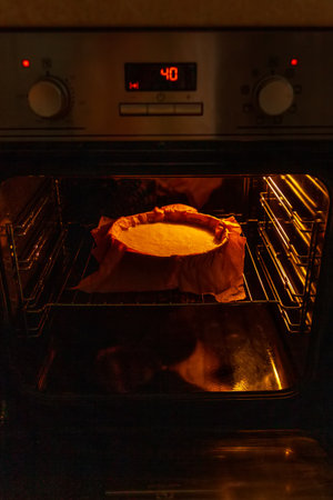 Cooking process homemade Basque burnt cheesecake. The form covered paper with the dough is in the oven and baked. Recipe step by stepの写真素材
