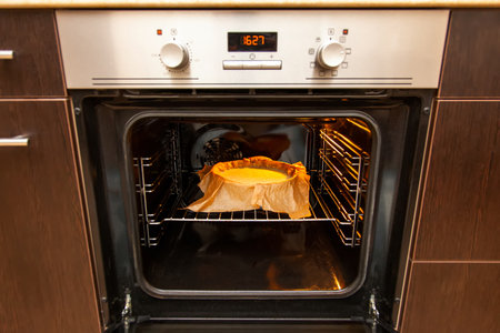 Cooking process homemade Basque burnt cheesecake. The form covered paper with the dough is in the oven and baked. Recipe step by stepの写真素材