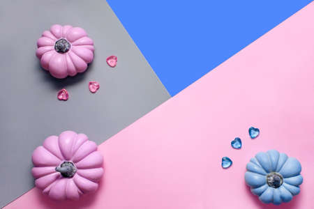 Autumn background with pink and blue pumpkins and glass hearts in pastel shades, top view with copy spaceの写真素材
