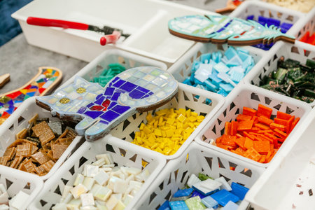 Master class on making mosaic panels. Close-up of the baskets with pieces of multi-colored material...