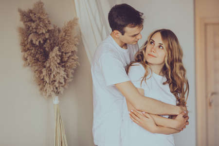 Close up portrait of young attractive romantic couple hugging and kissing, being loving with each other. Love and relationships lifestyle.の写真素材