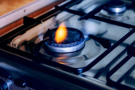 Kitchen gas hob, stove cook with blue and orange flames burning.の写真素材