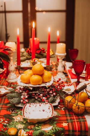 Christmas serving at home with tangerines, fruits, berries. Waiting for guests.の写真素材