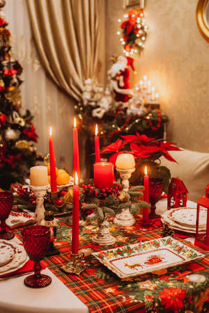 Christmas serving at home on the background of the Christmas tree. Waiting for guests.の写真素材
