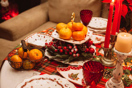 Christmas serving at home with tangerines, fruits, berries. Waiting for guests.の写真素材