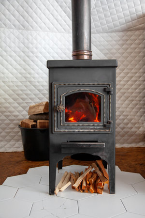 A vintage stove is heated with wood, heats a country house.の写真素材