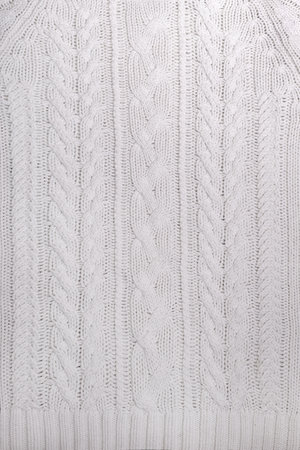 The texture of a white knitted sweater in close-up.の写真素材