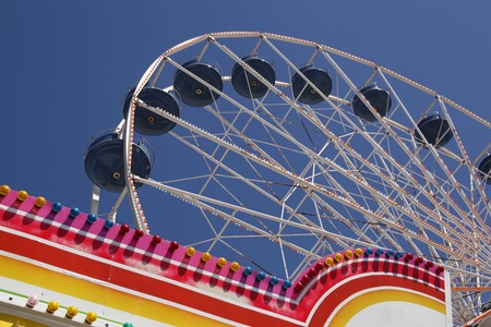 Ferris wheel with colorful light bulbs on the beach boardwalk