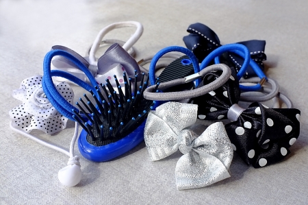 A few elastic hair bands - simple and in the shape of bows and flowers - and a small hair-brush の写真素材