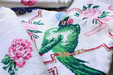 Table-cloth and table-napkins with embroidered parrot, flowers and decorative ornamentの写真素材