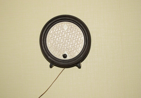 Old radio receiver set of 50s of XX century hanging on the wallの写真素材