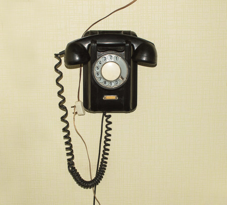 Old telephone set of 50s of XX century hanging on the wallの写真素材
