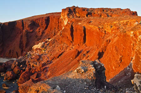 Red beach in Santorini, Greece in sunset lightの写真素材