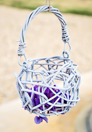 Small basket with purple flower on wedding arch.の写真素材