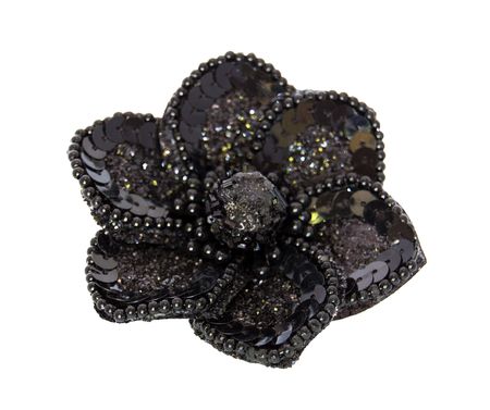Black decorative flower with beads and spangles isolated on a white backgroundの写真素材