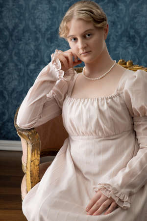 A Regency woman with blonde hair wearing a pink dressの写真素材