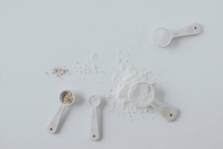 Tablespoon with flour and white elements.の写真素材