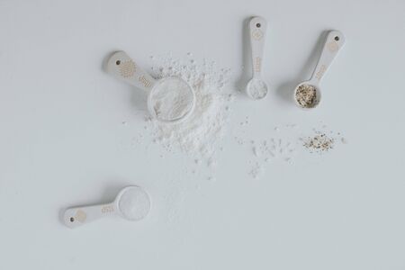 Measurement spoons over white table.の写真素材