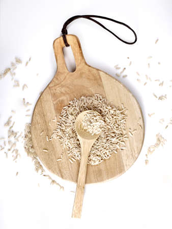 Brown rice in a wooden spoon. Top view.の写真素材