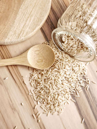 Uncooked brown rice in a decorative jar.の写真素材