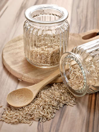 Uncooked brown rice in a decorative jars.の写真素材