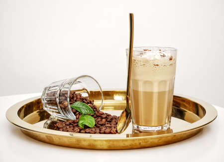 Caramel latte coffee in a tall glass.の写真素材