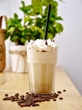 Caramel latte coffee in a tall glass.の写真素材