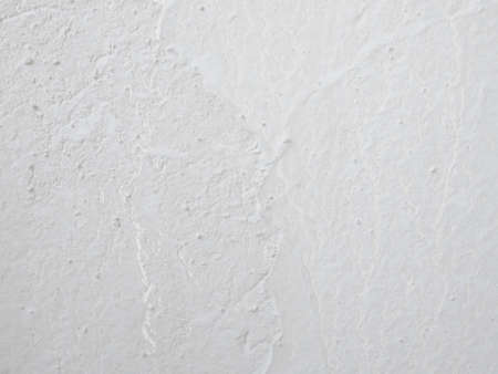 Cement or concrete wall texture. Destroyed surface. Grunge background in bright gray tones.