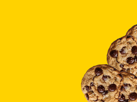 Sunny yellow paper with chocolate chip cookies. sweet biscuits. Homemade pastries. Food background with place for text.の写真素材