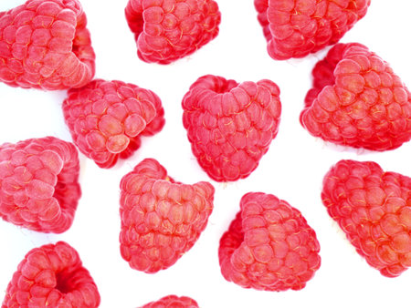 Fresh raspberries on white table. A healthy snack for the summer.