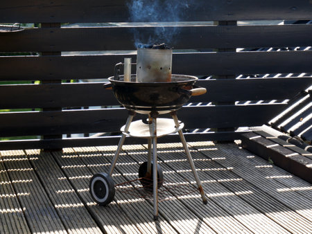 The grill grate in subtle smoke. A summer day on the terrace.の写真素材