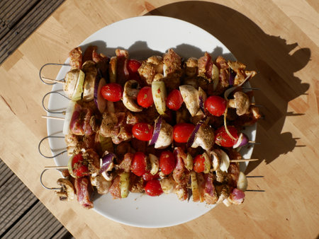 Skewers of vegetables and raw poultry meat prepared for the barbecue.の写真素材