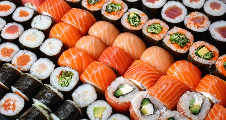 Sushi with fish - Nigiri and Futomaki. Tasty food with umami flavor. A great snack loved by everyone. Close-up of the detail.の写真素材